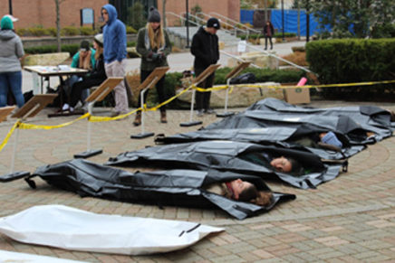 SUNY students lay in body bags to illustrate climate change’s deadly effects