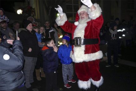 Santa helps to light up the hamlet in Highland with festive colors